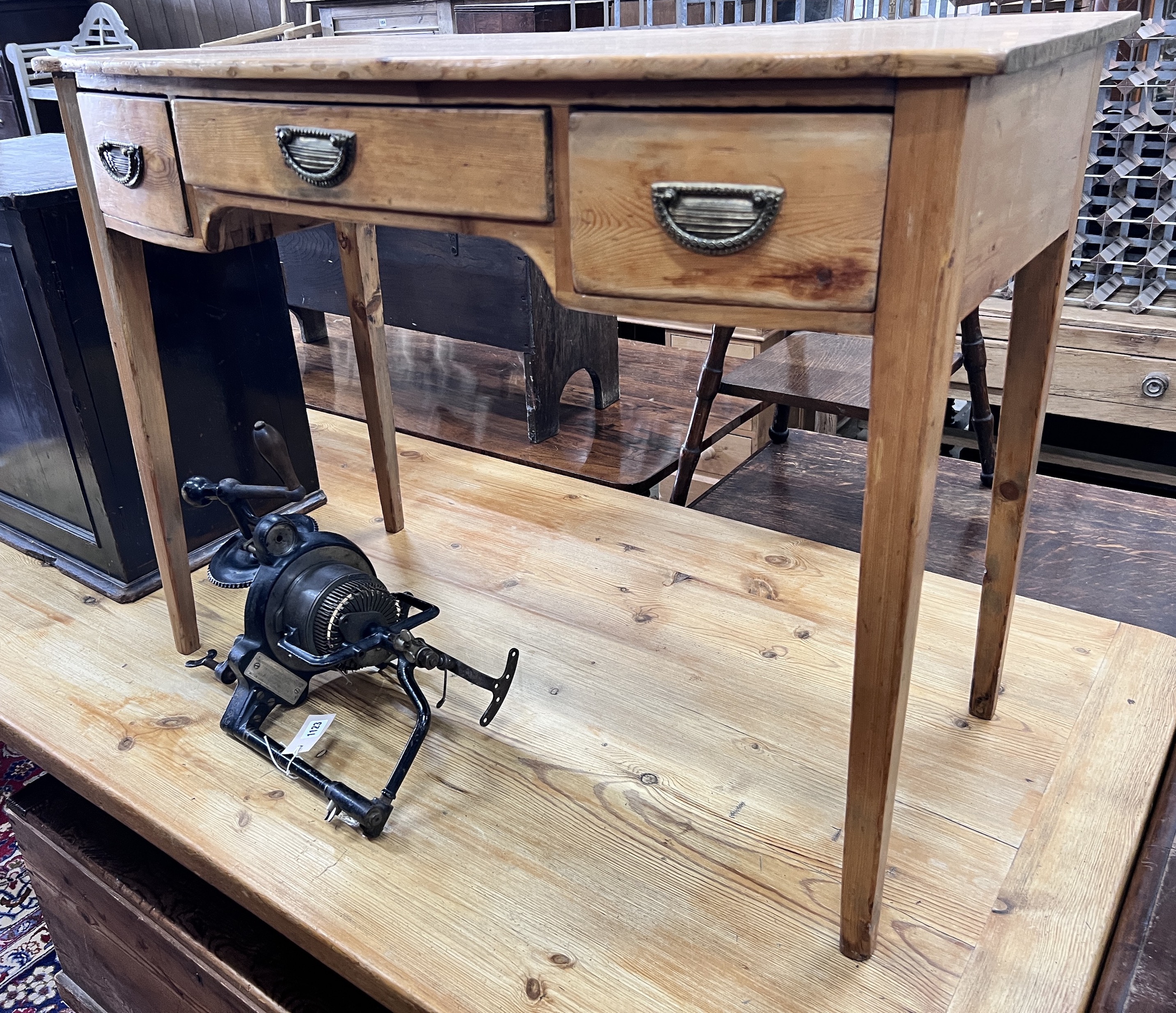 An early 19th century pine bow front three drawer side table, width 97cm, depth 50cm, height 73cm